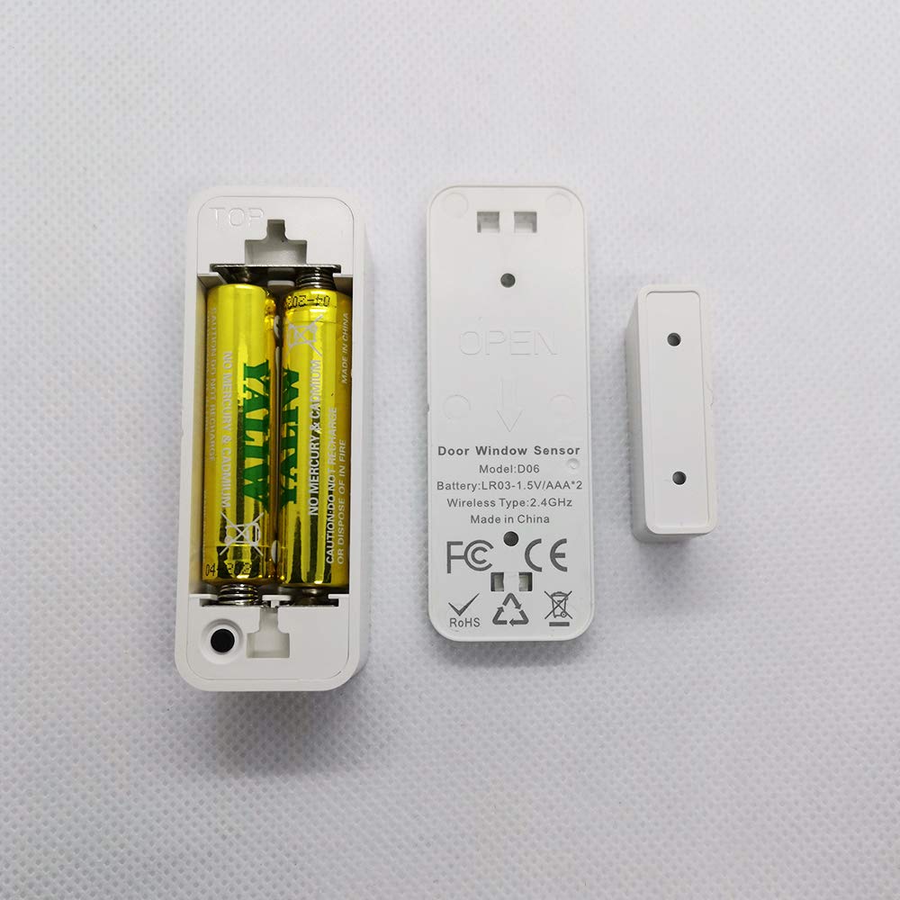 Original photo of the OKOS door sensor battery compartment and rear label beside its magnet.